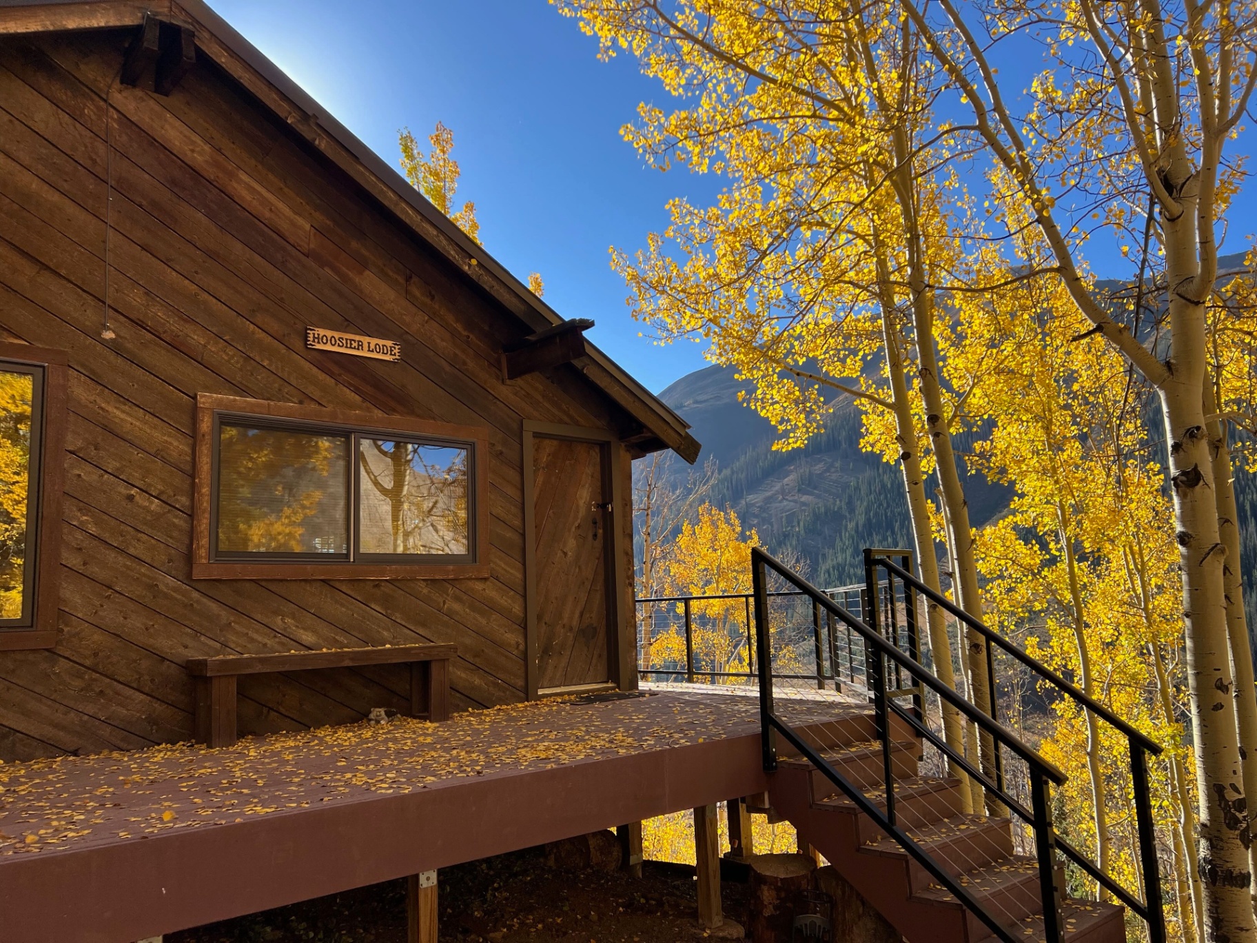 The Hoosier cabin exterior in autumn, surrounded by golden aspens
